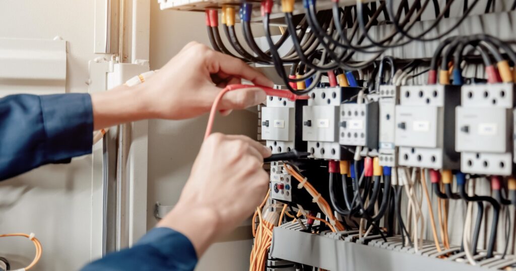 Electrician servicing a home electrical panel in Spokane