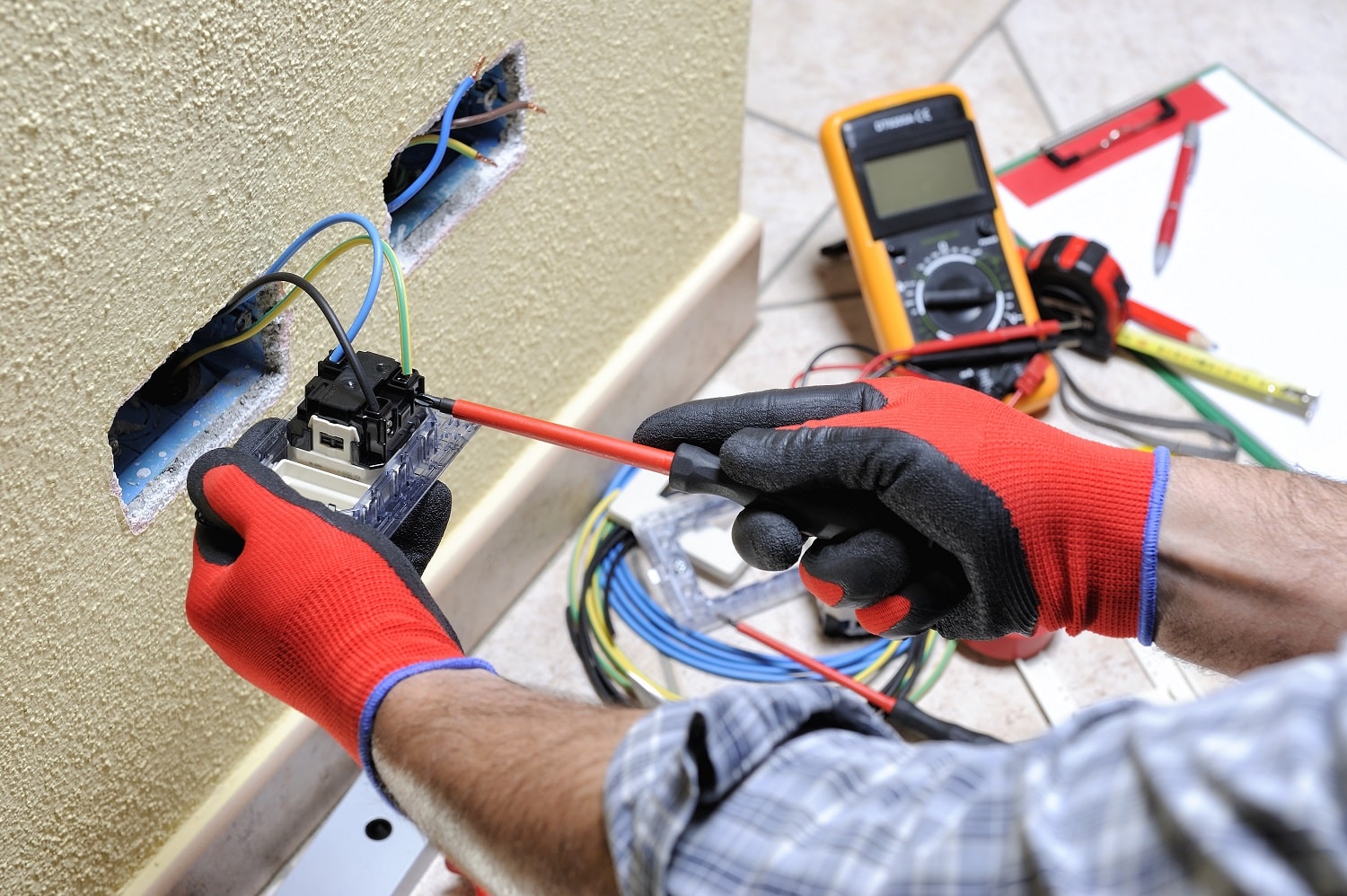 Electrician Technician At Work With Safety Equipment On A Residential Electrical System Electrician Technician At Work With Safety Equipment On A Residential Electrical System
