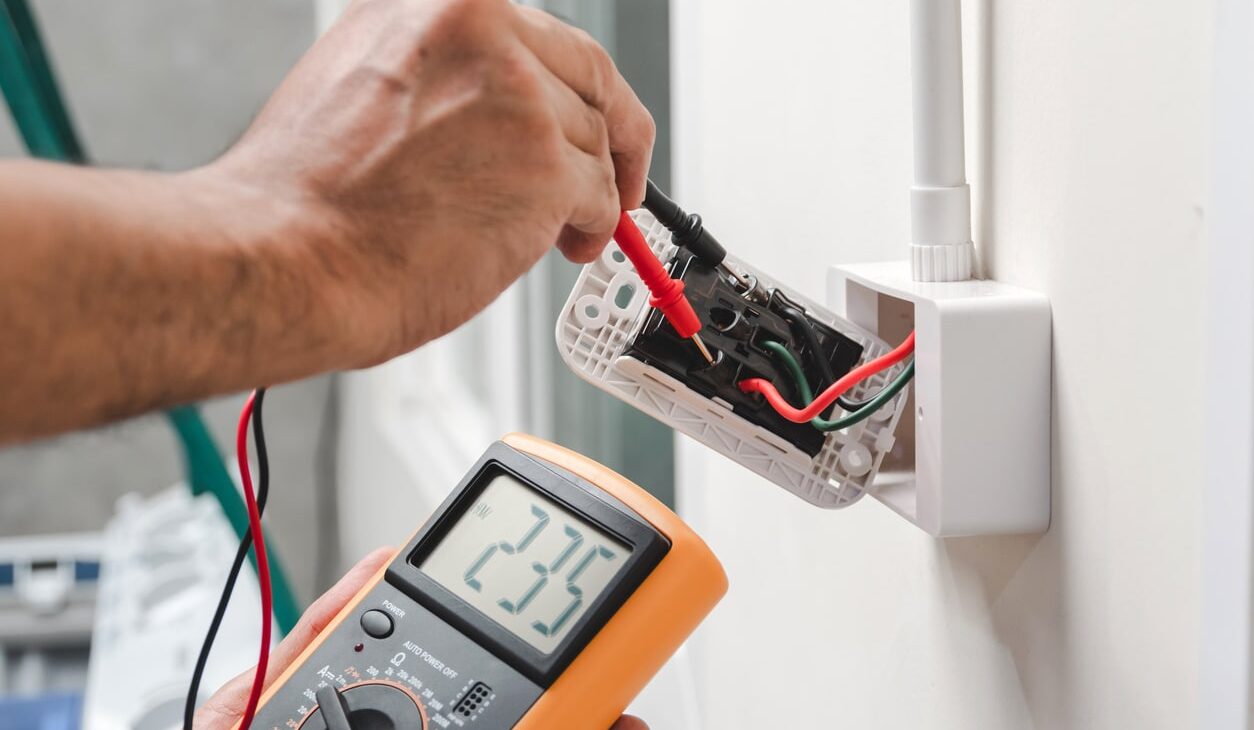 Code Corrections & Safety Inspections Electrician Technician At Work With Safety Equipment On A Residential Electrical System